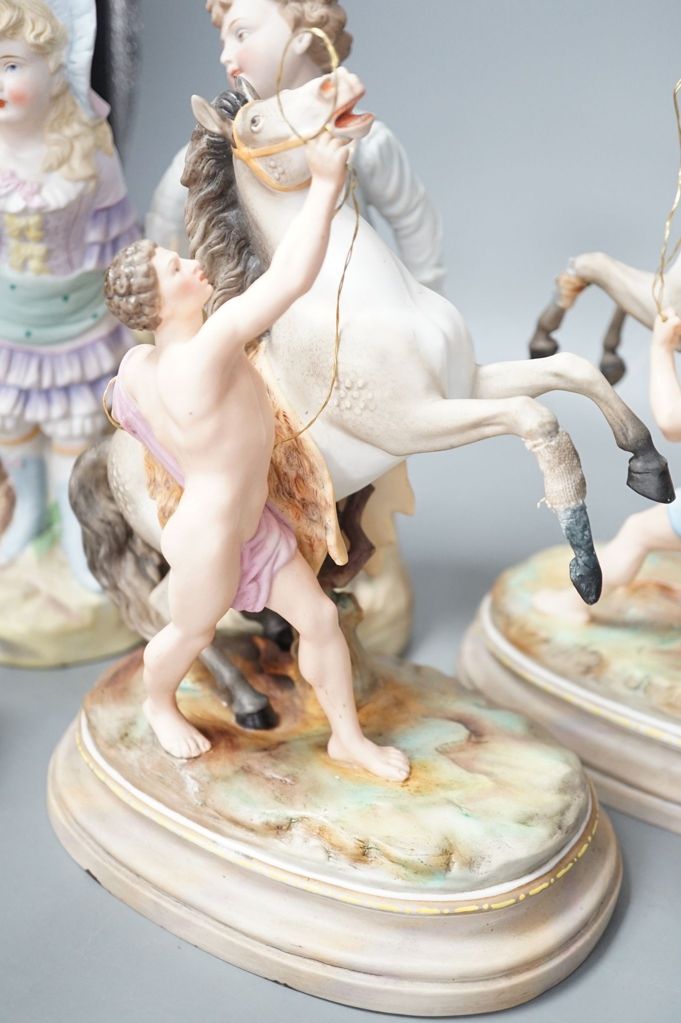 A pair of French bisque Marly horse groups and two pairs of French porcelain figures 27cm